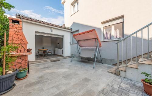 a balcony with a ladder on a house at 1 Bedroom Cozy Apartment In Povljana in Povljana