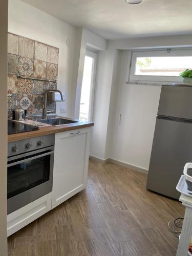 a kitchen with a sink and a stove at Goti Rooms B&B in SantʼAgata deʼ Goti