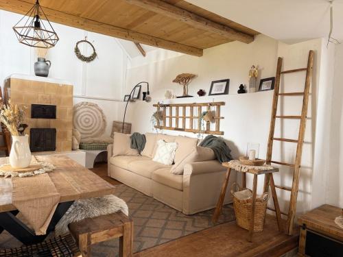 a living room with a couch and a table at Baglyashegy Vendégház in Sümeg