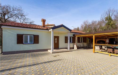 a house with a patio and a roof at Gorgeous Home In Rukavac With Kitchen in Rukavac