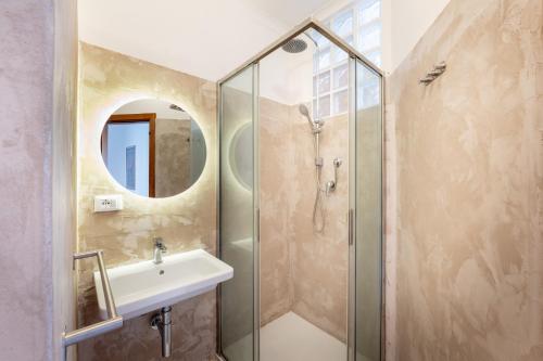 a bathroom with a sink and a shower at La Maison Blanche - Fano Historical Center in Fano