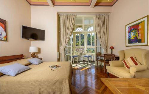 a bedroom with two beds and a living room with a window at Villa Mediteran in Dubrovnik