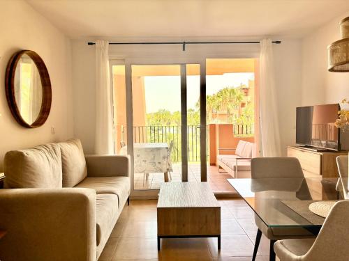 a living room with a couch and a table at Sun and Golf Holidays at Mar Menor Golf Resort in Torre-Pacheco