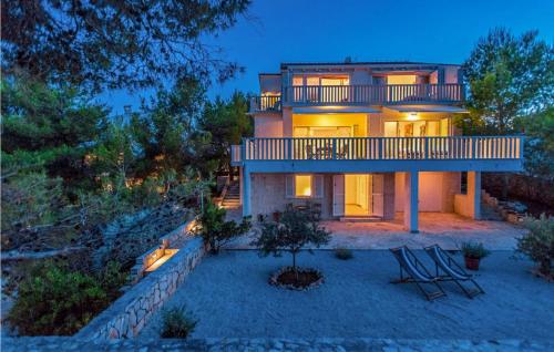a large house with a balcony on top of it at Villa Aqua in Vrbanj