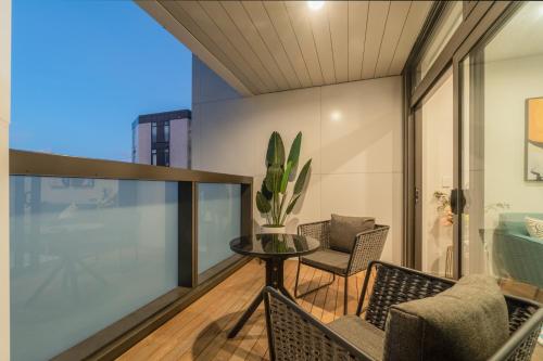 a balcony with a table and chairs on it at 3 Bedroom Apartment in Epsom in Auckland