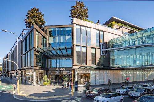 a large building with cars parked in front of it at 3 Bedroom Apartment in Epsom in Auckland