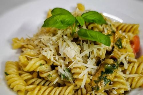 a plate of pasta with cheese and basil on top at Kafana Zlatna Ribica in Golubac
