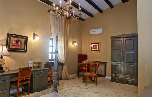 a dining room with a table and a chandelier at Villa Carolus Barat in Barat
