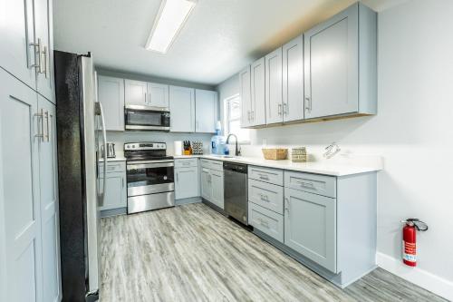 a kitchen with white cabinets and stainless steel appliances at Roosevelt Inn in Jacksonville