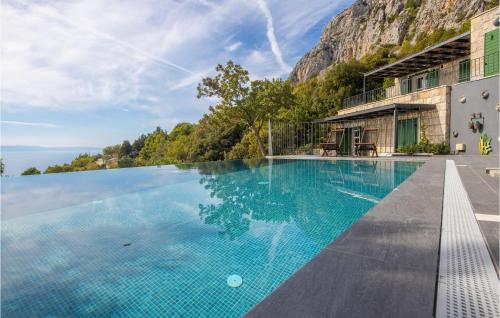 a swimming pool with a mountain in the background at Villa 2M in Makarska