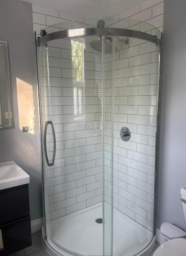 a shower with a glass door in a bathroom at 925 Rentals in Hamilton