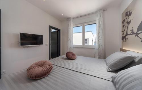 a bedroom with a bed with two ottomans at Villa Royal House 3 in Pašman