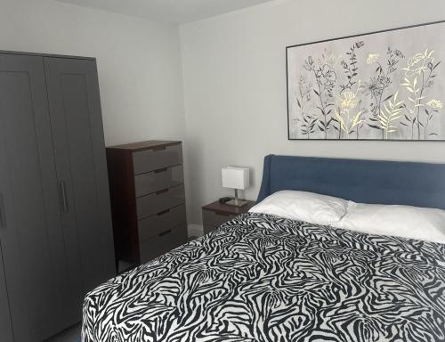 a bedroom with a bed with a black and white blanket at 925 Rentals in Hamilton
