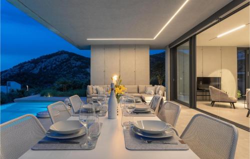 a dining room with a table and chairs and a television at Villa Magic Sunset in Hvar