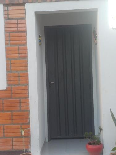 a black door on the side of a brick wall at Avodah in Caña de Castilla