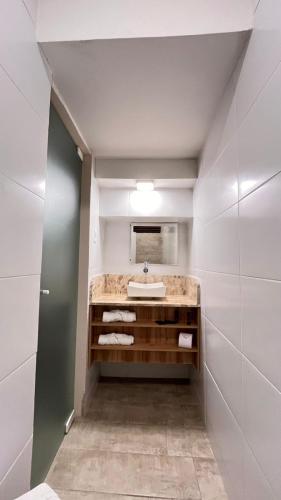 a bathroom with a sink and a mirror at Casarão Suítes Maragogi in Maragogi