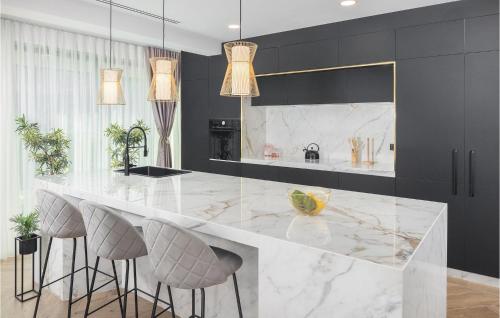 a kitchen with a large marble counter and stools at Villa Golden Shine in Poreč