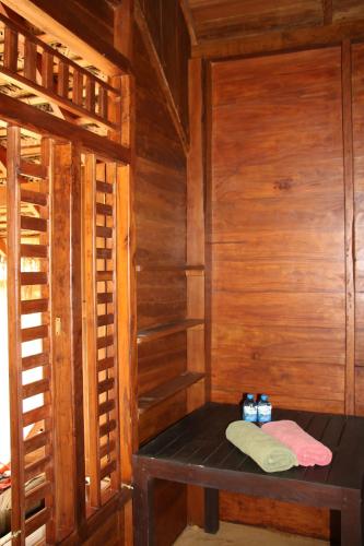 a wooden room with a bench in a room with wooden walls at Shiva's Beach Cabanas in Tangalle