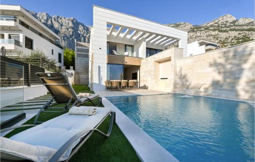 a villa with a swimming pool and a house at Nice Home In Makarska With Jacuzzi in Makarska