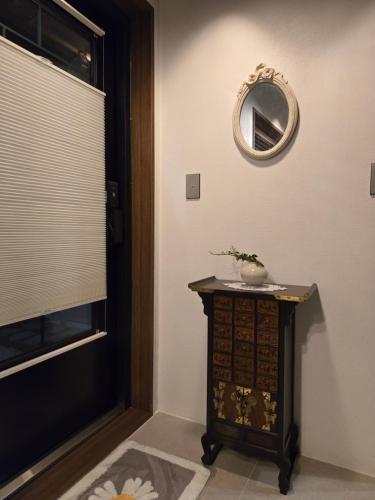 a room with a table and a mirror on the wall at Stay Yeojin Yeomong in Gyeongju