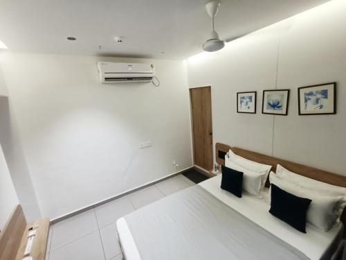 a bedroom with a bed and a air conditioner at KANT by GoHotels - Near Shree Dwarkadhish Temple in Dwarka