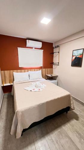 a bedroom with a large bed in a room at Casarão Suítes Maragogi in Maragogi