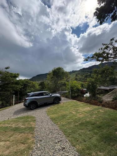 a car parked in the driveway of a house at Tiny House at Finca Haug in San Pablo