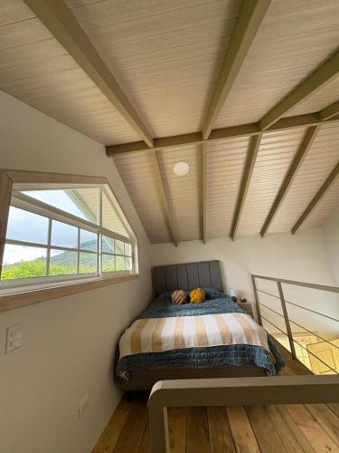 a bedroom with a bed in a room with a window at Tiny House at Finca Haug in San Pablo