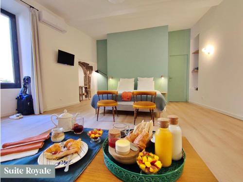 a living room with a table with food on it at Le Prince - Maison d'hôtes in Marseillan