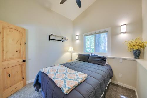 a bedroom with a bed and a window at Steps to Lakefront Home Near Schweitzer Mtn! in Sagle