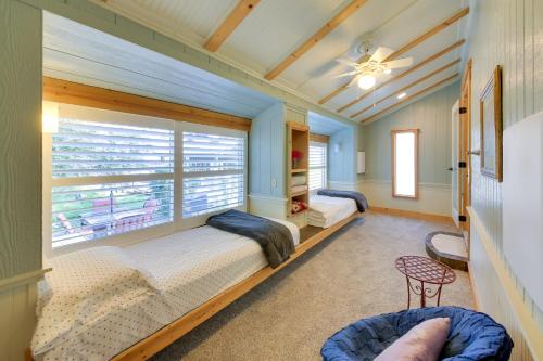 two beds in a room with a window at Steps to Lakefront Home Near Schweitzer Mtn! in Sagle