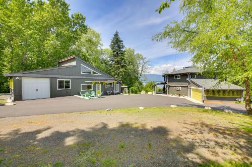 a house with a driveway and a garage at Steps to Lakefront Home Near Schweitzer Mtn! in Sagle