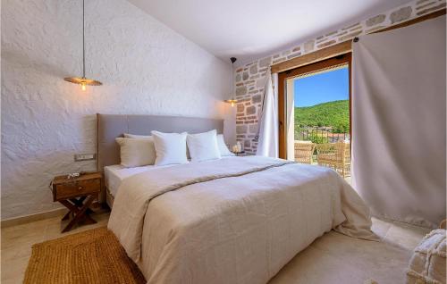a bedroom with a large bed with a large window at Gorgeous Home In Cera With Wifi 