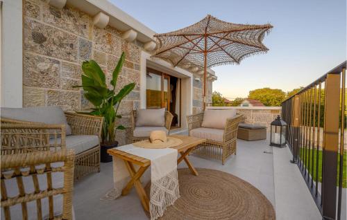 a patio with a table and chairs and an umbrella at Gorgeous Home In Cera With Wifi 