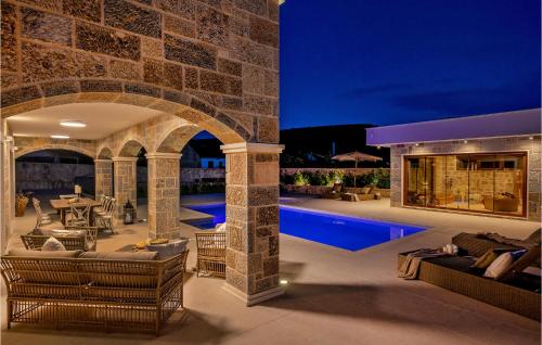 an outdoor patio with a fireplace and a swimming pool at Gorgeous Home In Cera With Wifi 