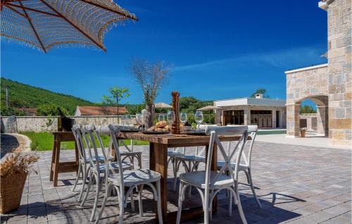 a patio with a wooden table and chairs at Gorgeous Home In Cera With Wifi 