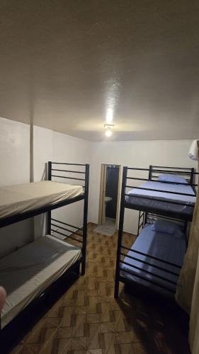two bunk beds in a room with a ceiling at Hostel & Privativo in Manaus