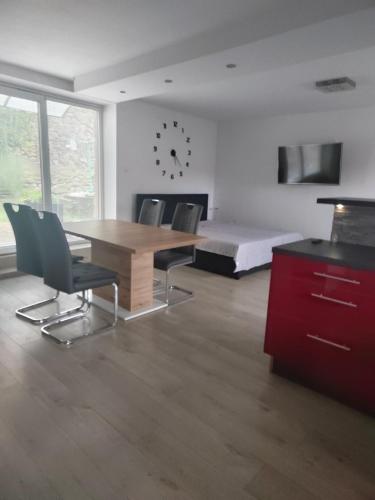 a room with a table and chairs and a bed at Ubytování Zdeňka in Chudenice