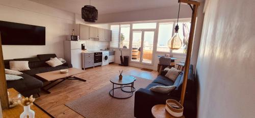 a living room with a couch and a table at Votre COCON Niçois in Nice