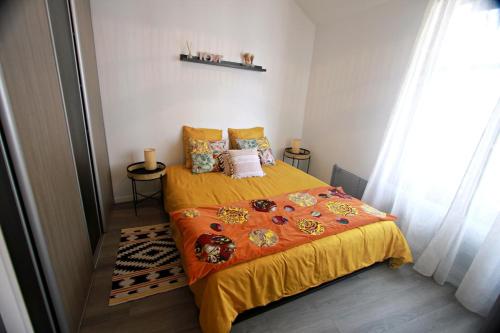 a bedroom with a bed with a yellow bedspread at Apartment with Exceptional View in Périgueux
