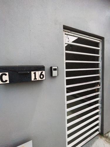a sign on the side of a door with the number at Casa Campo Alegre in Bayamon