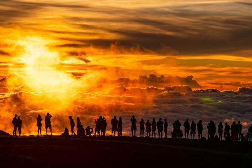 a group of people standing in front of a sunset at CampCar Maui Jeeps SUVs Hybrid Camper van Rentals with equipment and Travel Advice in Kahului