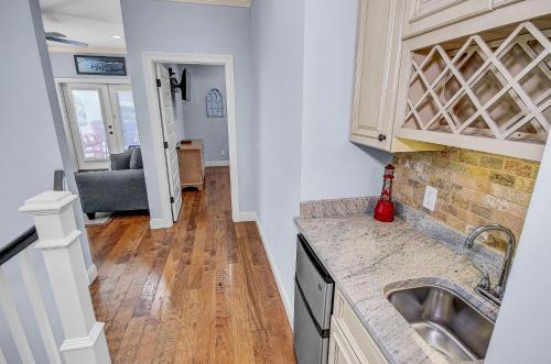 a kitchen with a sink and a living room at 5 Bed, 5 Bath Beach Home/Only a 3 Minute Walk To The Beach! SLEEPS 12 in Sunnyside