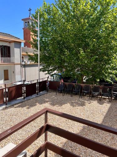 a patio with chairs and a table and a tree at Residenza Colonna in Lanuvio