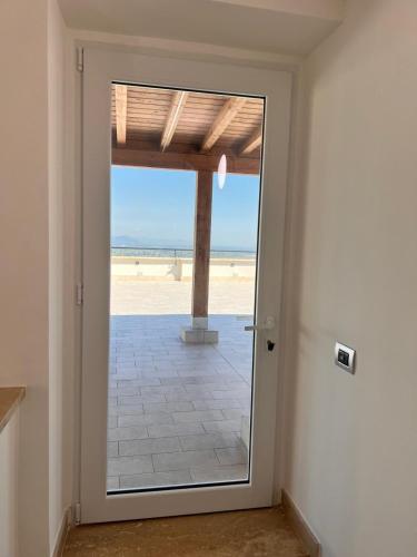 a door with a view of the beach at Residenza Colonna in Lanuvio