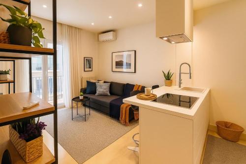 a small living room with a couch and a kitchen at Andreas and Nelly in Thessaloniki
