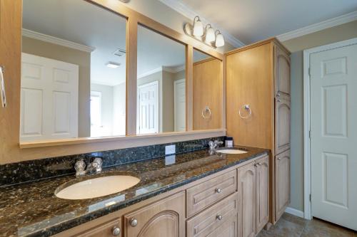 a bathroom with two sinks and two mirrors at Summer Dayz - Families Love It Here, Just Across from the Beach in Panama City Beach
