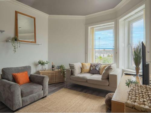 a living room with two chairs and a couch at Pitchside Escape in Ayr