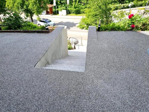 a pair of concrete stairs in a park with trees at White Sand Haven Guest House in Ebhausen