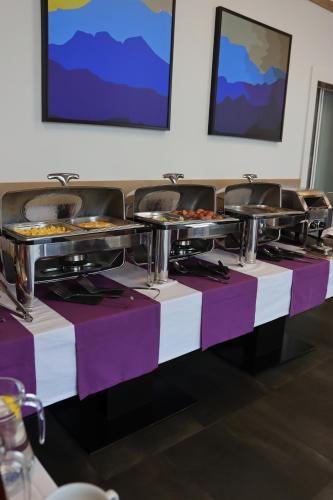 a row of tables with plates of food on them at VILSON hotel in Bukovel